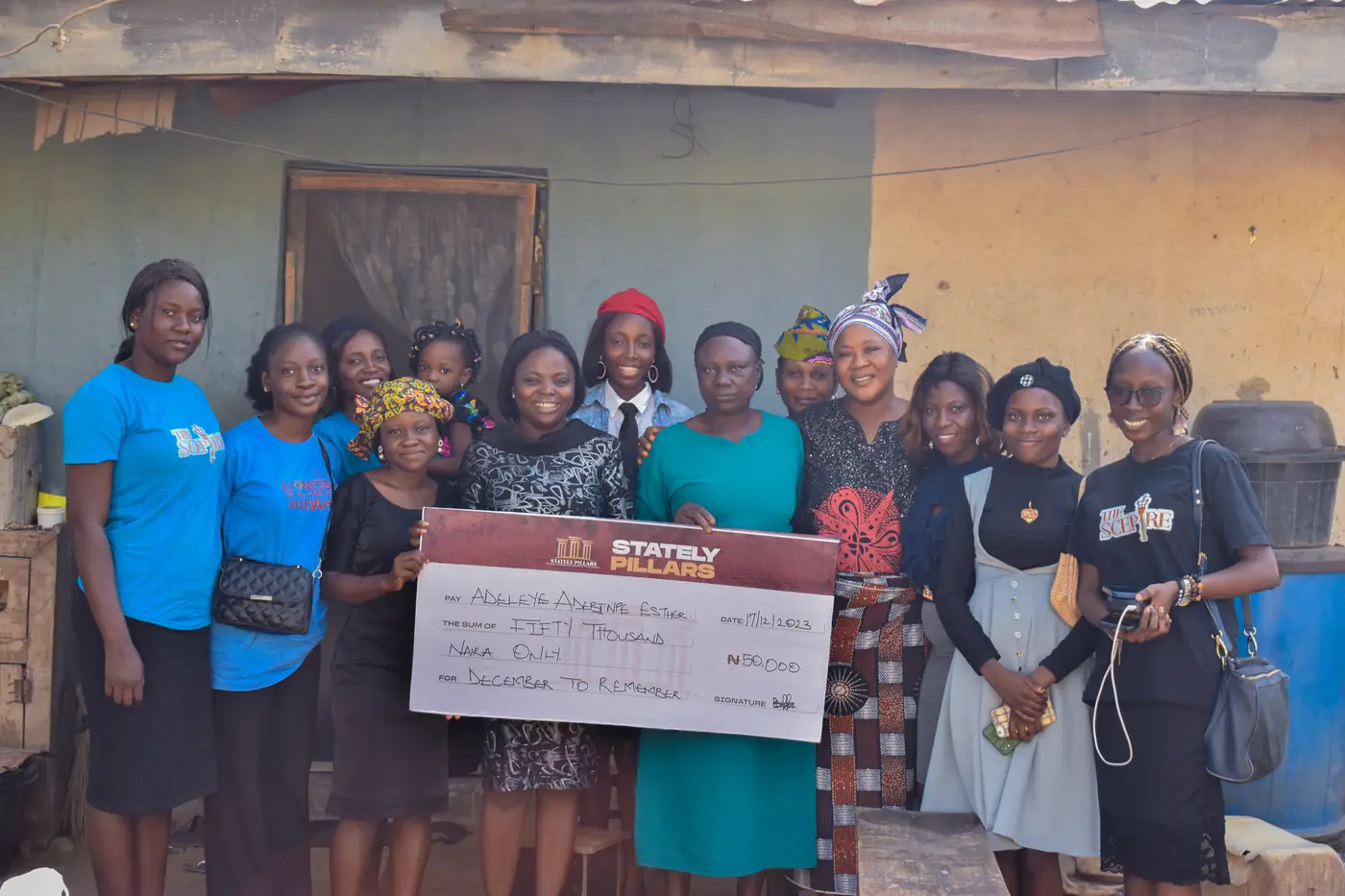 The team with a widow and her empowerment cheque