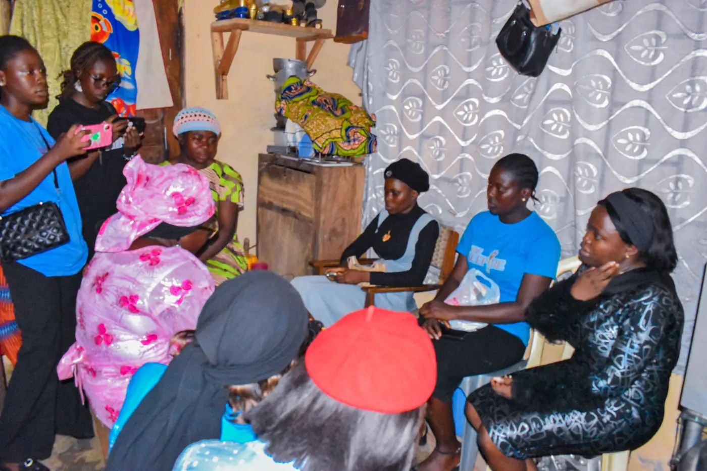 The team visiting a widow at home