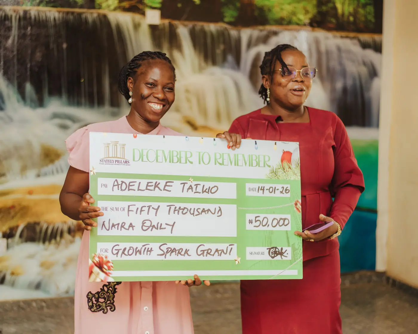 A recipient holding her grant cheque