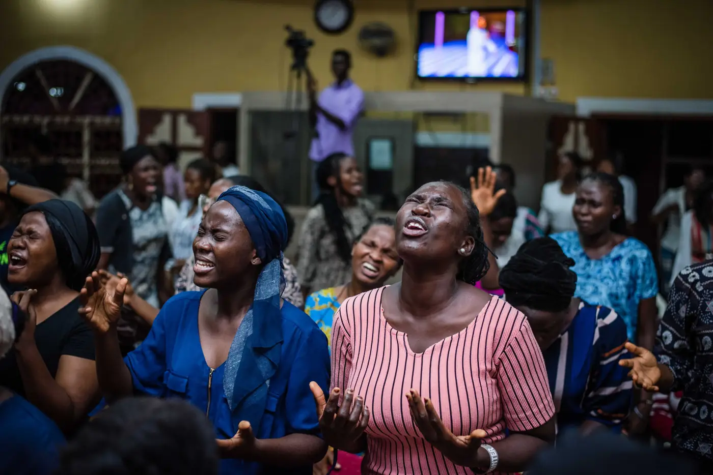 Women worshipping with hands open