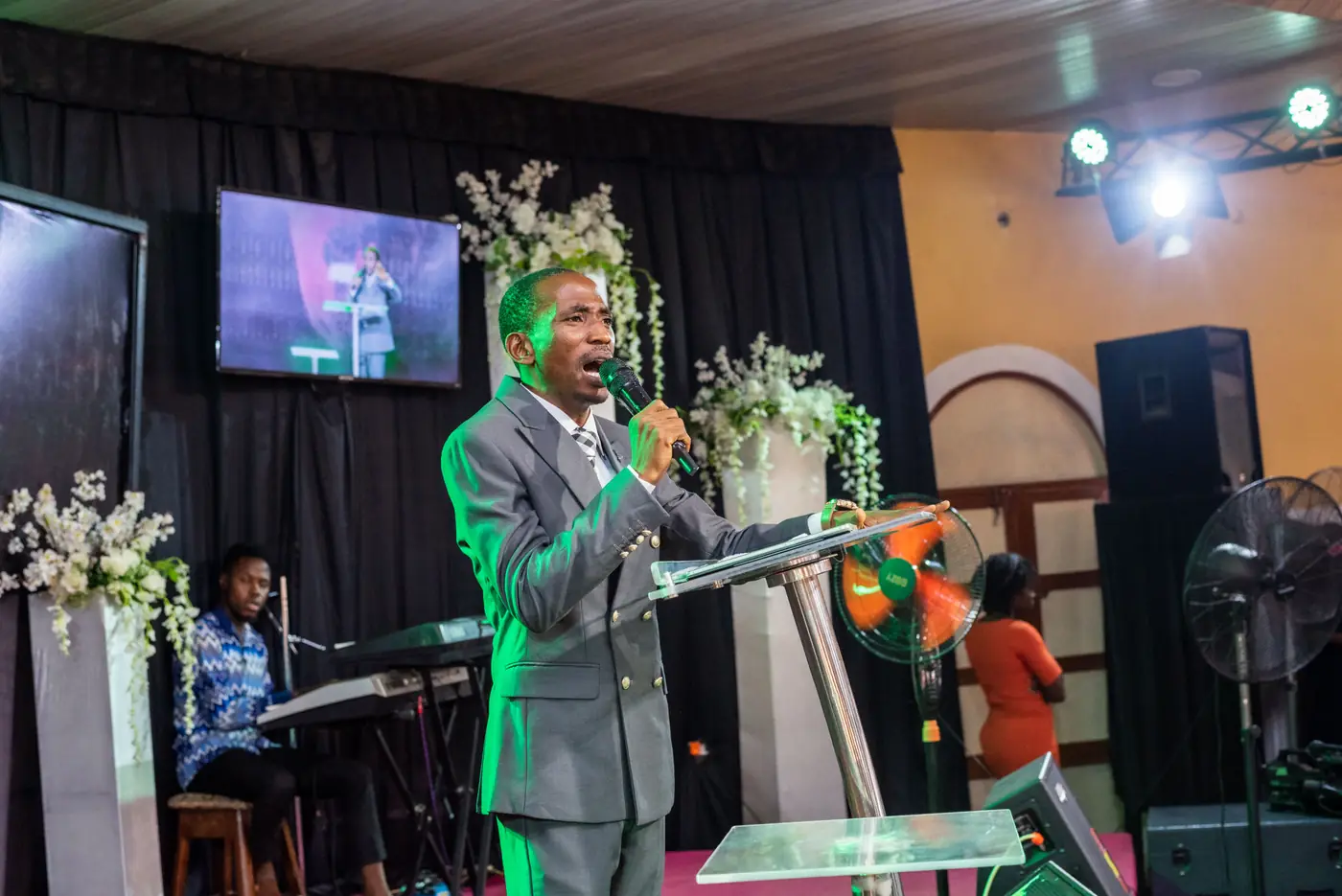 A minister speaking from the stage