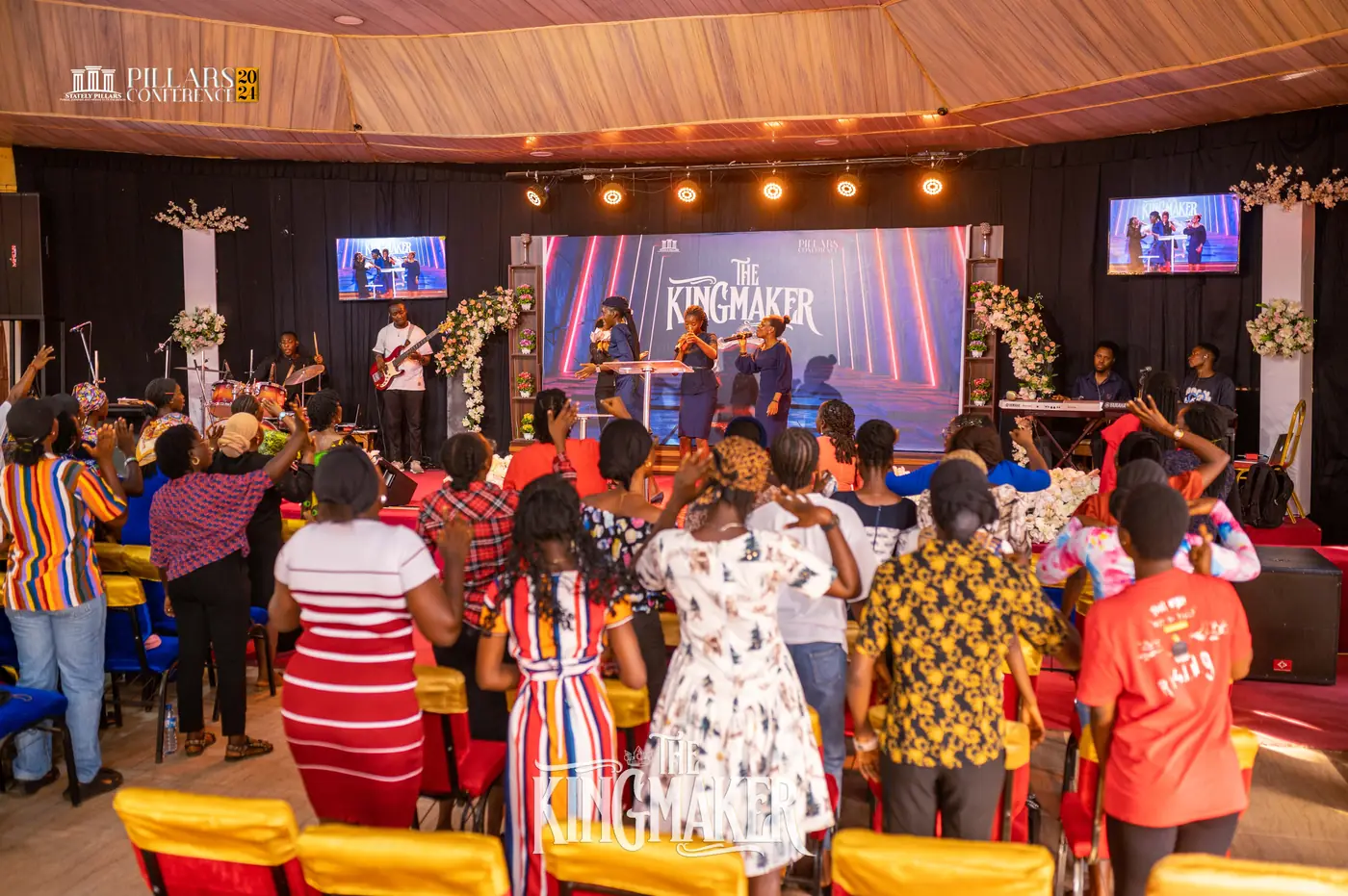 The hall standing in worship facing the stage