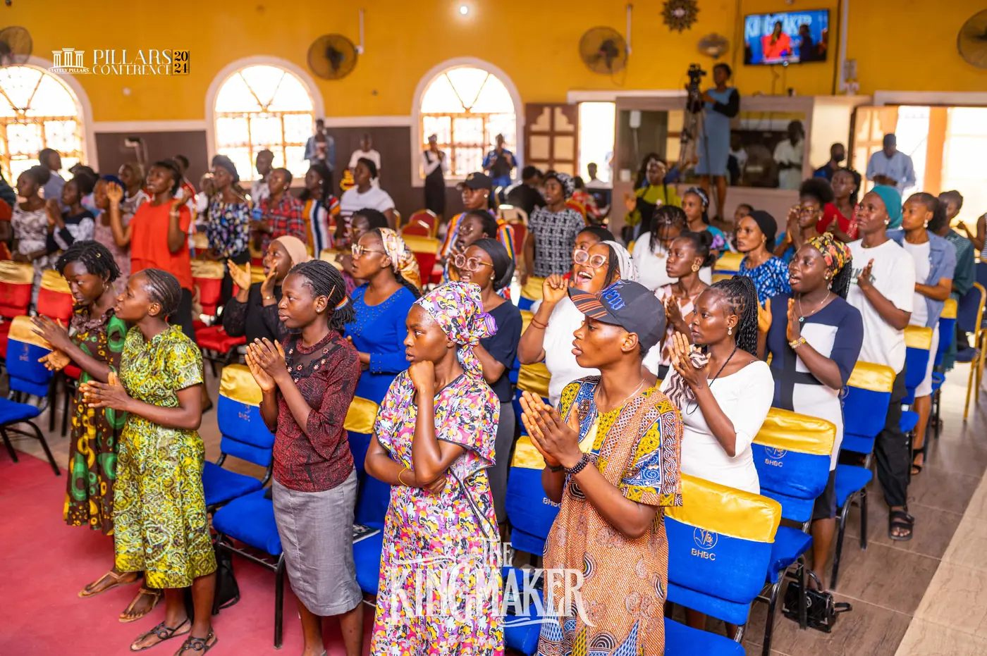The congregation clapping in praise