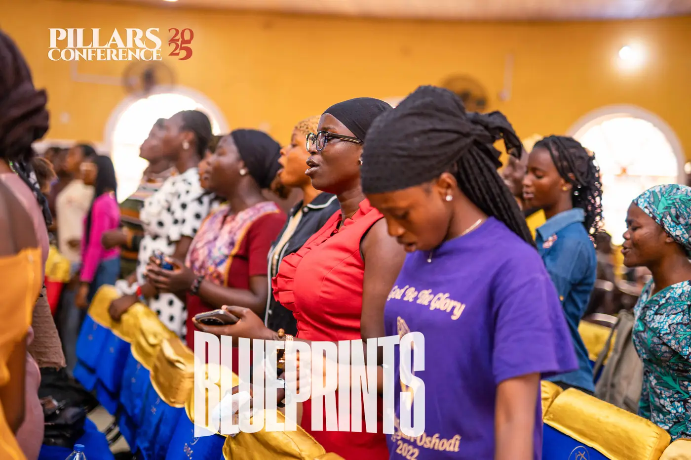 Women standing in worship at Pillars Conference 2025