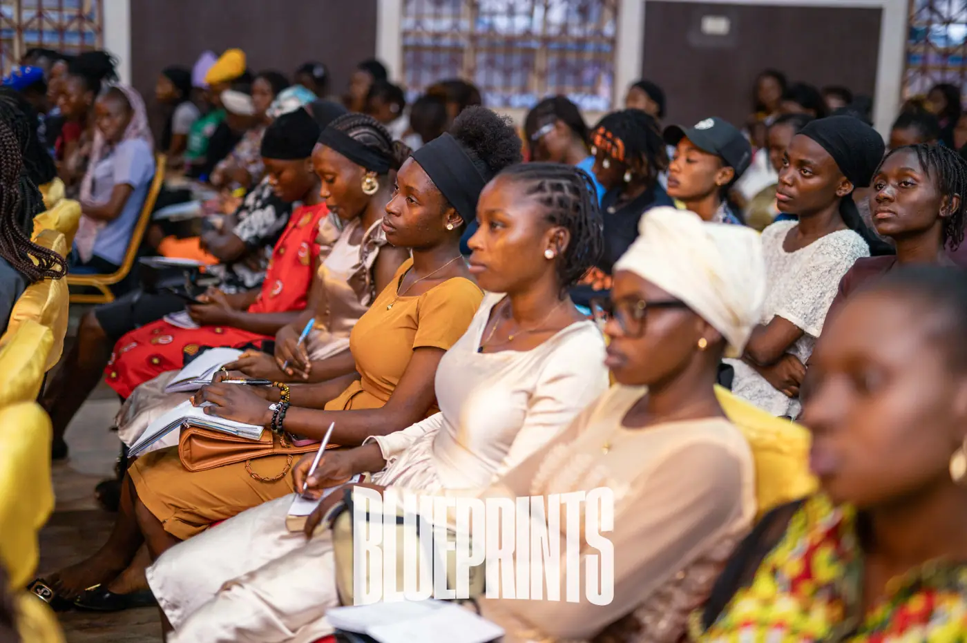 Young women taking notes during a session