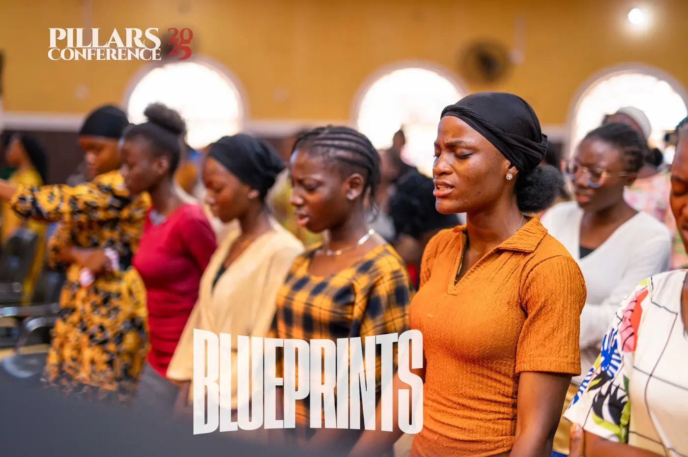 Young women worshipping with eyes closed